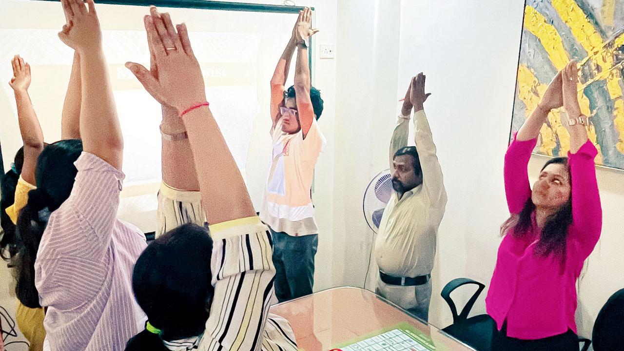 Employees practise an exercise at work