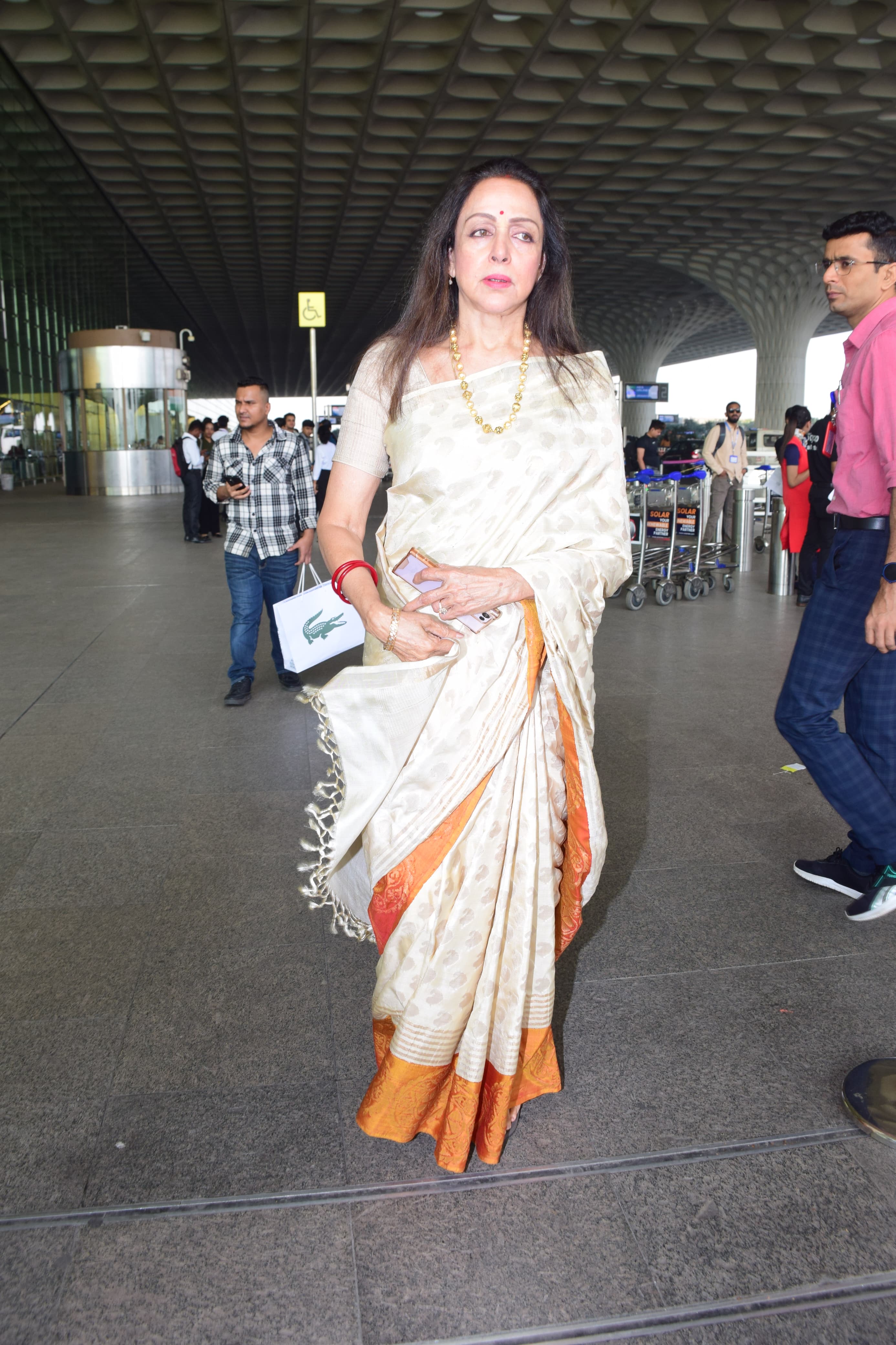 Hema Malini looked beautiful in a white saree with orange border as she got clicked in the city