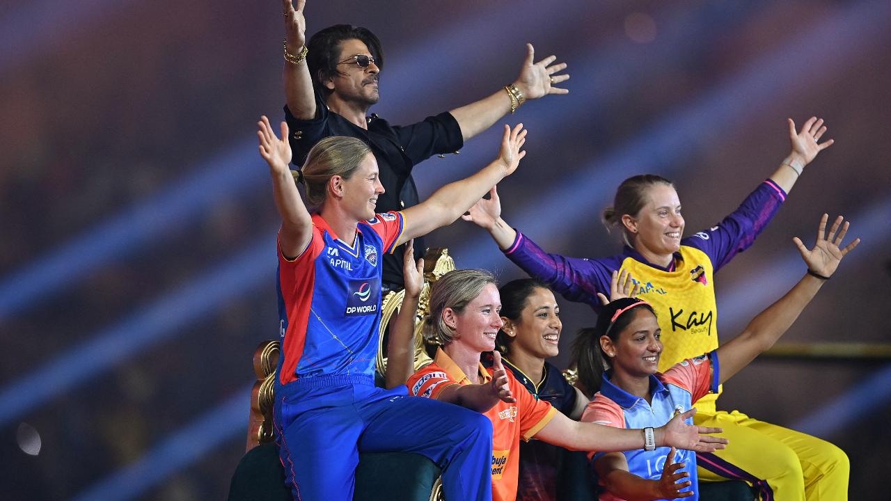 Bollywood actor Shah Rukh Khan (L, top) and WPL teams' captains gesture during the opening ceremony of 2024 Women's Premier League