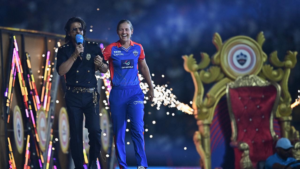 Delhi Capitals' captain Meg Lanning (R) and Bollywood actor Shah Rukh Khan gesture during the opening ceremony of 2024 Women's Premier League (WPL)