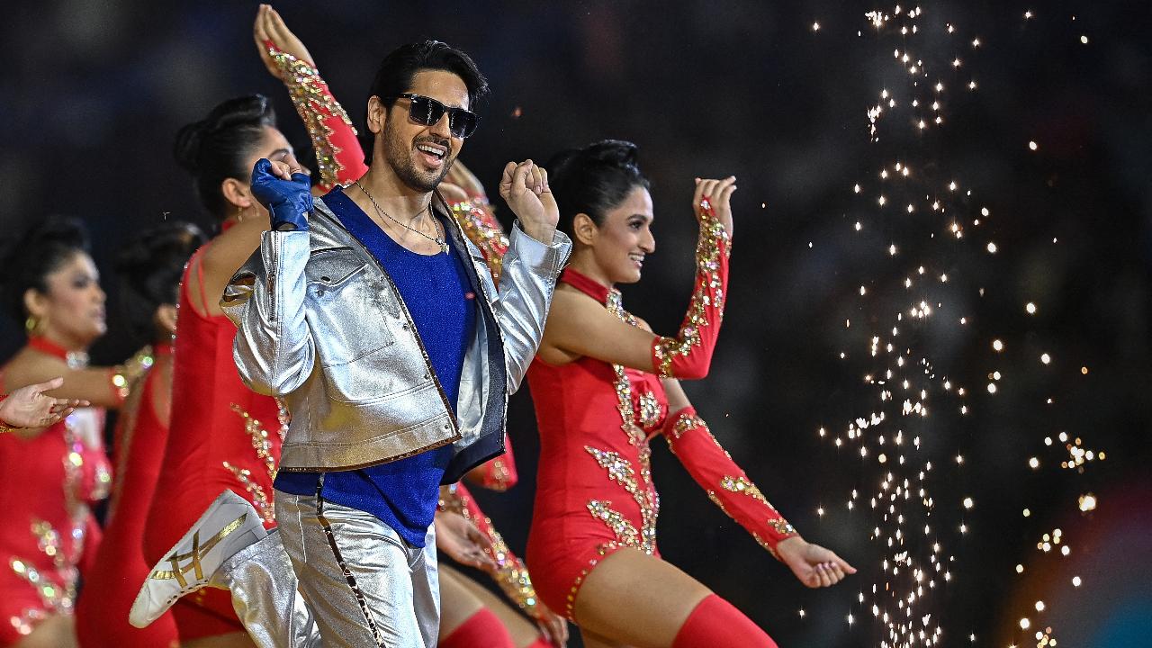 Bollywood actor Sidharth Malhotra (C) performs for the opening ceremony of 2024 Women's Premier League (WPL) before the start of first Twenty20 cricket match