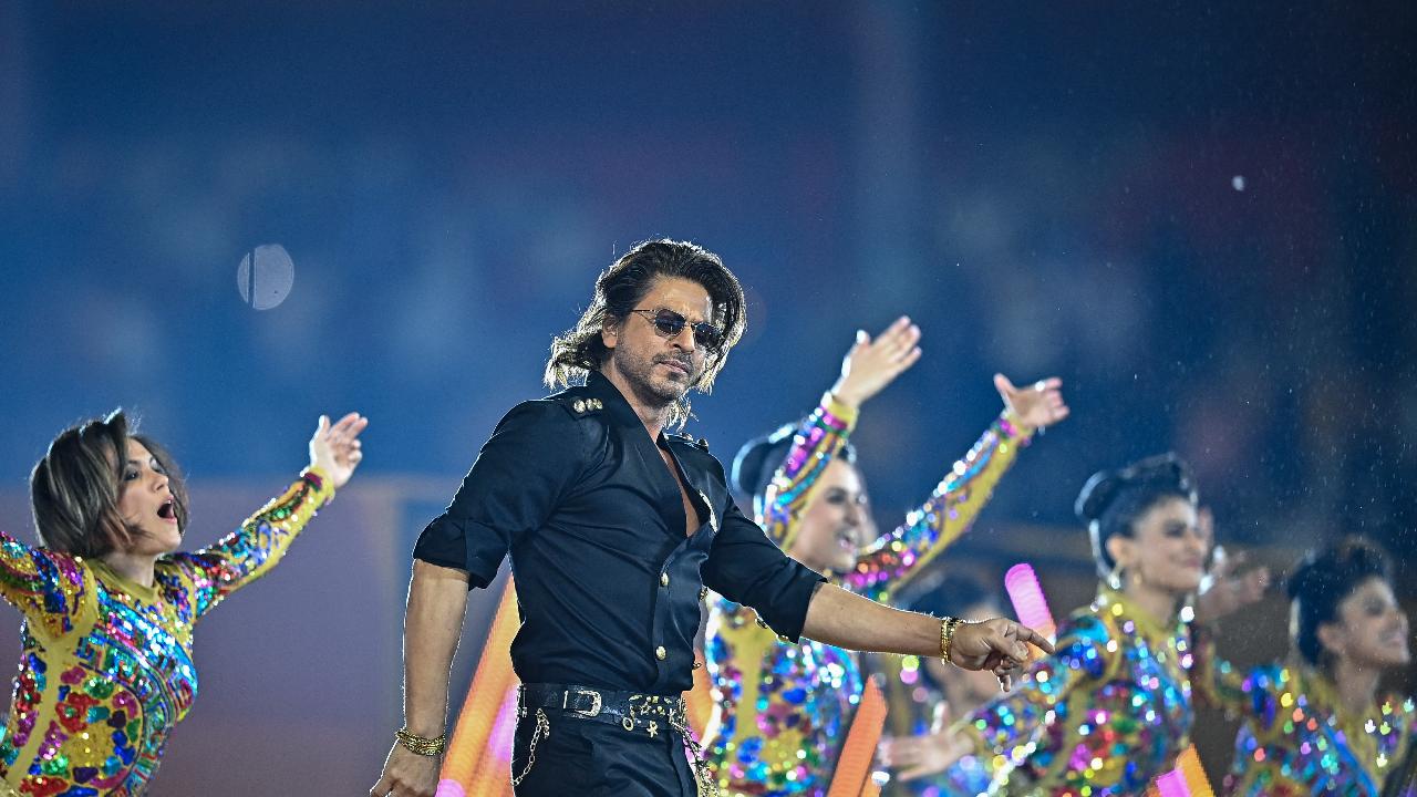 Bollywood actor Shah Rukh Khan (2L) performs for the opening ceremony of 2024 Women's Premier League (WPL) before the start of first Twenty20 cricket match between Mumbai Indians and Delhi Capitals at the M. Chinnaswamy Stadium in Bengaluru