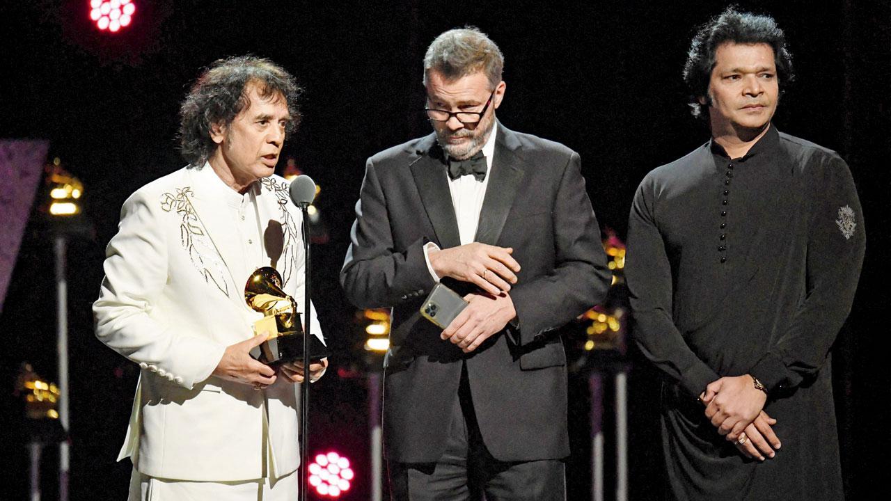 Hussain, Meyer and Chaurasia accept the Global Music Performance award. Pic/AFP