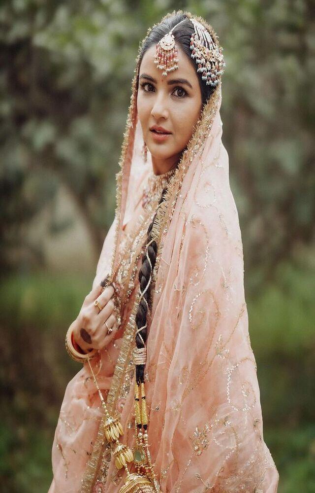She tied her hair in a long braid with a tassel at the tip like a typical Punjabi bride
