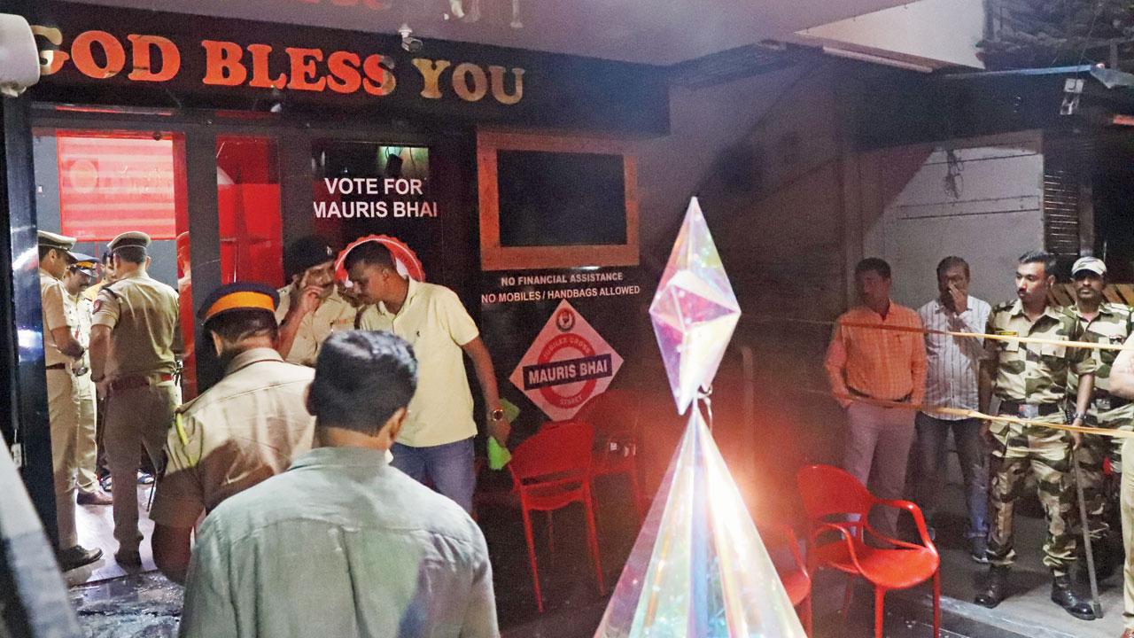 Police and other law enforcement personnel outside Mauris Noronha’s house in Borivli. Pic/Anurag Ahire