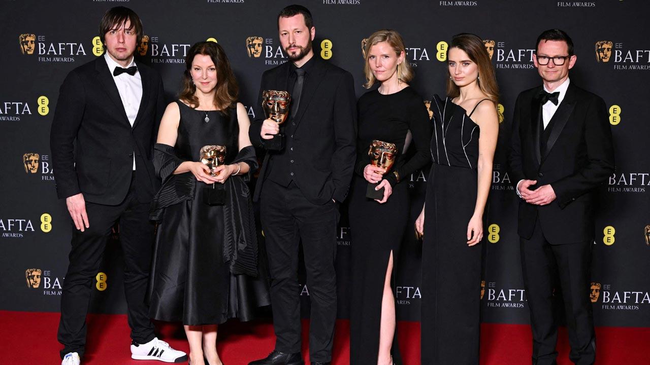 Ukrainian photojournalist Mstyslav Chernov, US film and documentary producer Raney Aronson Rath and US film and documentary producer Michelle Mizner pose with the award for Best documentary for "20 days in Mariupol" during the BAFTA British Academy Film Awards ceremony at the Royal Festival Hall, Southbank Centrer, in London. Pic/AFP