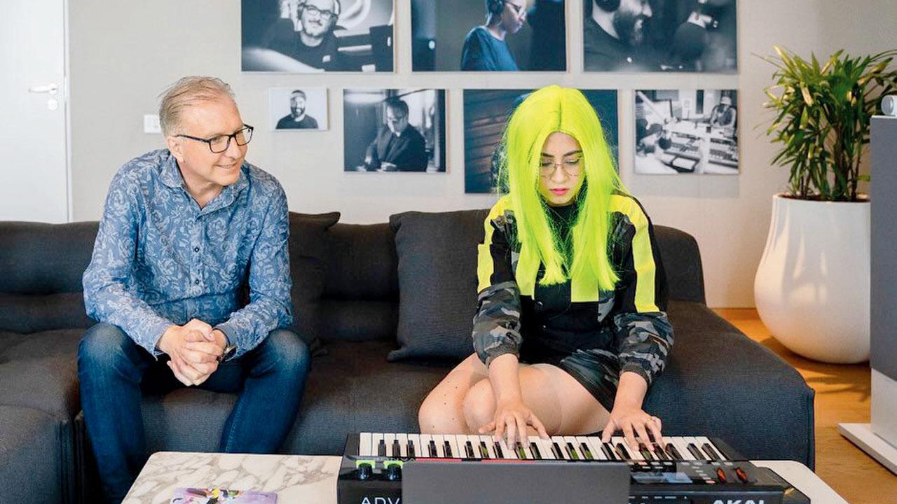 Music producer Komorebi shows (left) Greg Joswiak her work