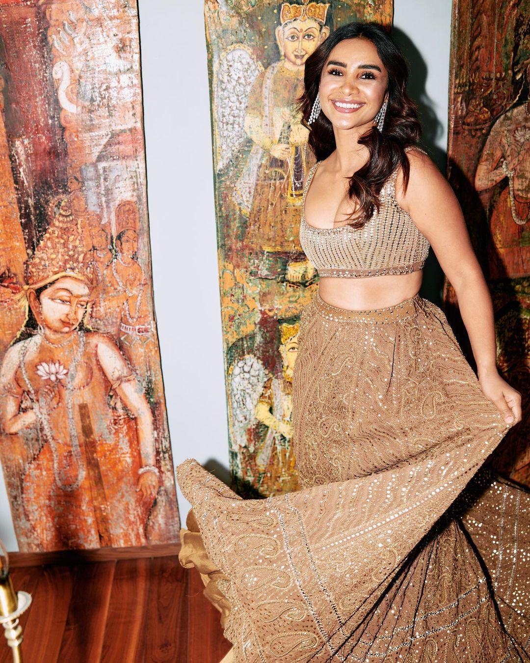 She left her hair open and put on chic earrings to elevate her appearance. The nude makeup is definitely a hit. Trust me; you won't be disappointed after wearing this lehenga outfit to your friend's reception