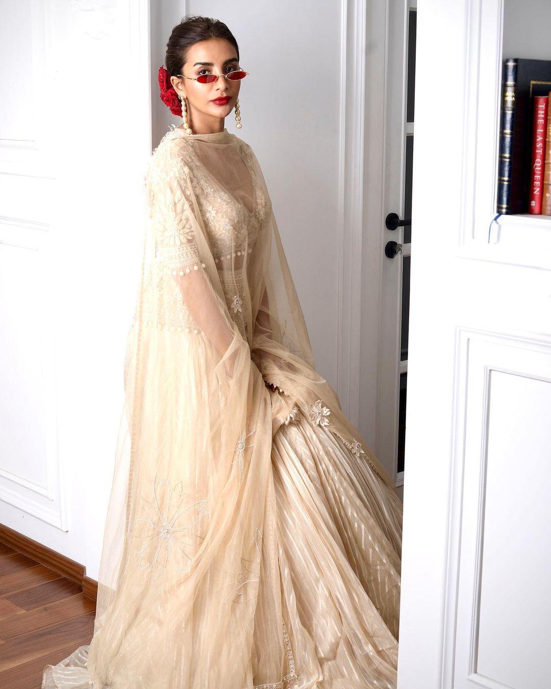 In this lehenga, Patralekhaa gives off the perfect royal vibe. The actress paired a white lehenga with a heavily embroidered blouse and a see-through sheer dupatta