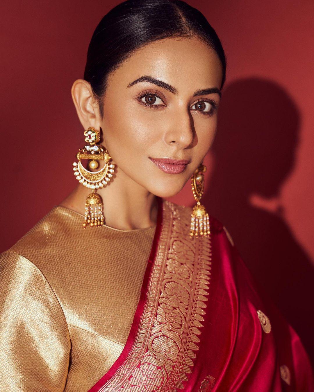 Opting for minimal jewellery, she chooses intricate heavy earrings and a nude makeup palette to achieve a flawless finish