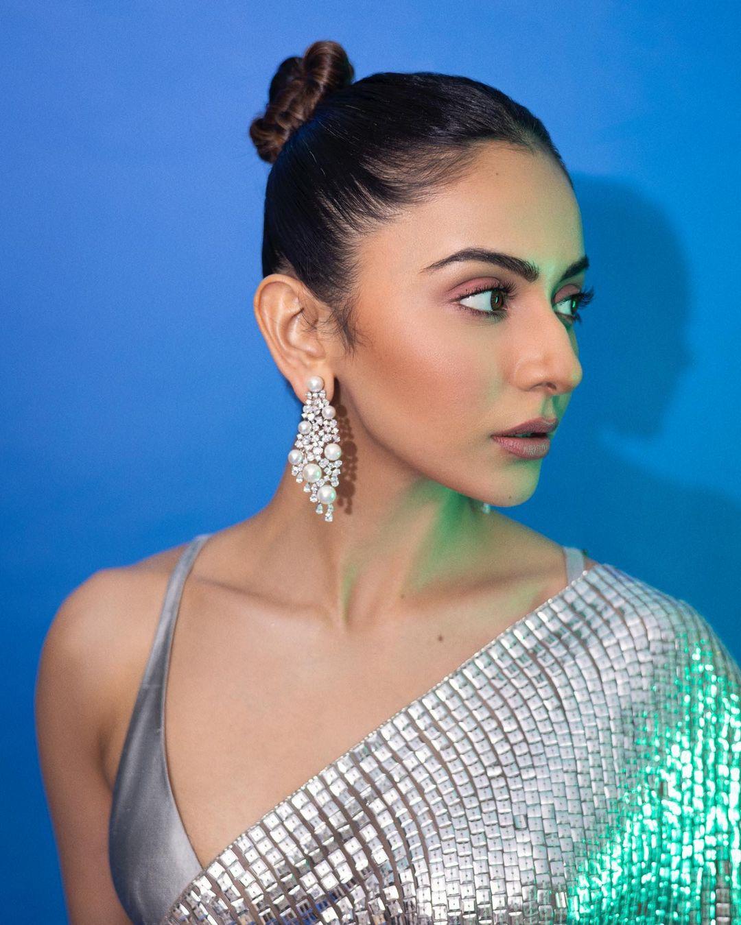 With a chic bun hairstyle and minimal makeup, Rakul lets her natural beauty shine through in this nude makeup look