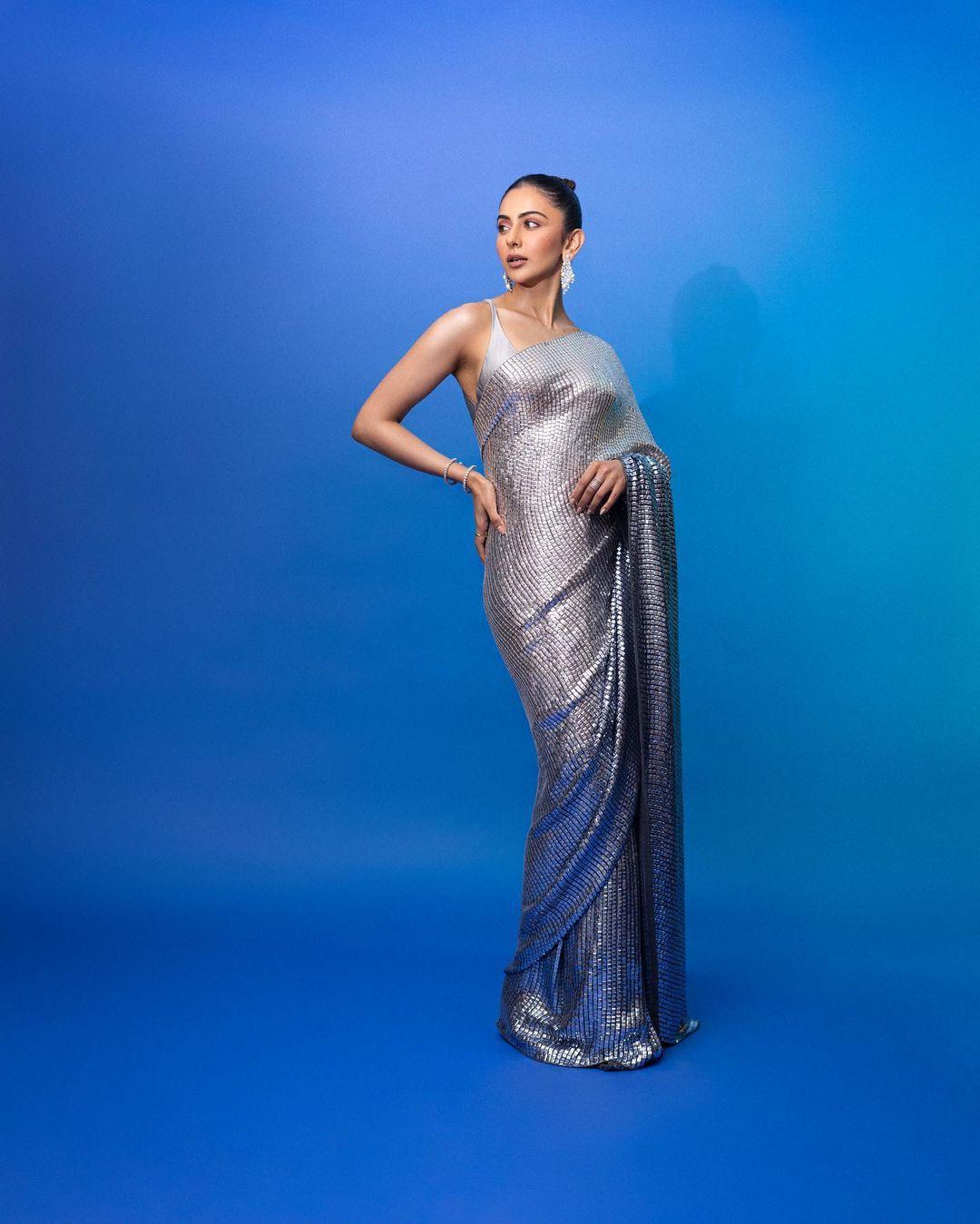 In another striking appearance, Rakul opts for a dazzling sequin saree complemented by a strappy silver blouse