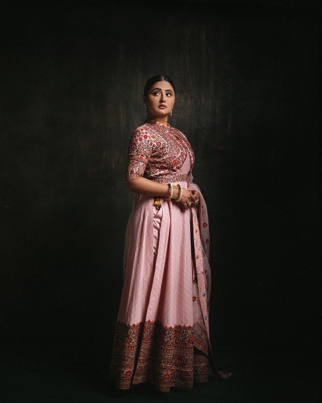 In another traditional appearance, Rashami captivates in a pink kurta paired with matching pants and dupatta. The beautiful intricate designs on the suit add a touch of sophistication. Tying her hair in braids imparts a unique and charming aspect to the overall look