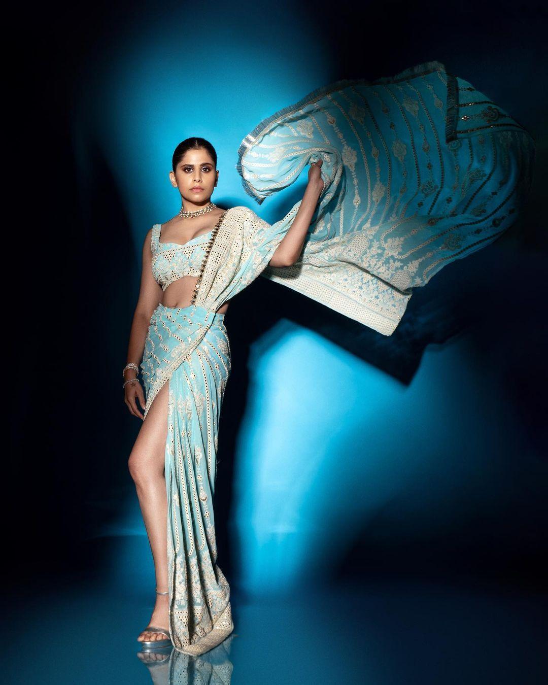 The stylish blue saree featured a thigh-high slit and beautiful mirror work. Sai paired it with a matching blouse, opting for a chic necklace instead of heavy jewellery