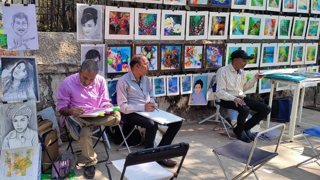 It was no different for Rakesh Sinha (in pink shirt), who came to Mumbai from Bihar. After working as an artist for some time, he joined the artists on the footpath between Rampart Road and CSMVS only a year before Kamble. Today, they are two of approximately 17 artists sitting on steel chairs on that footpath to earn their living as street artists. Today, he is happy that people appreciate his art and says that is all an artist wants.