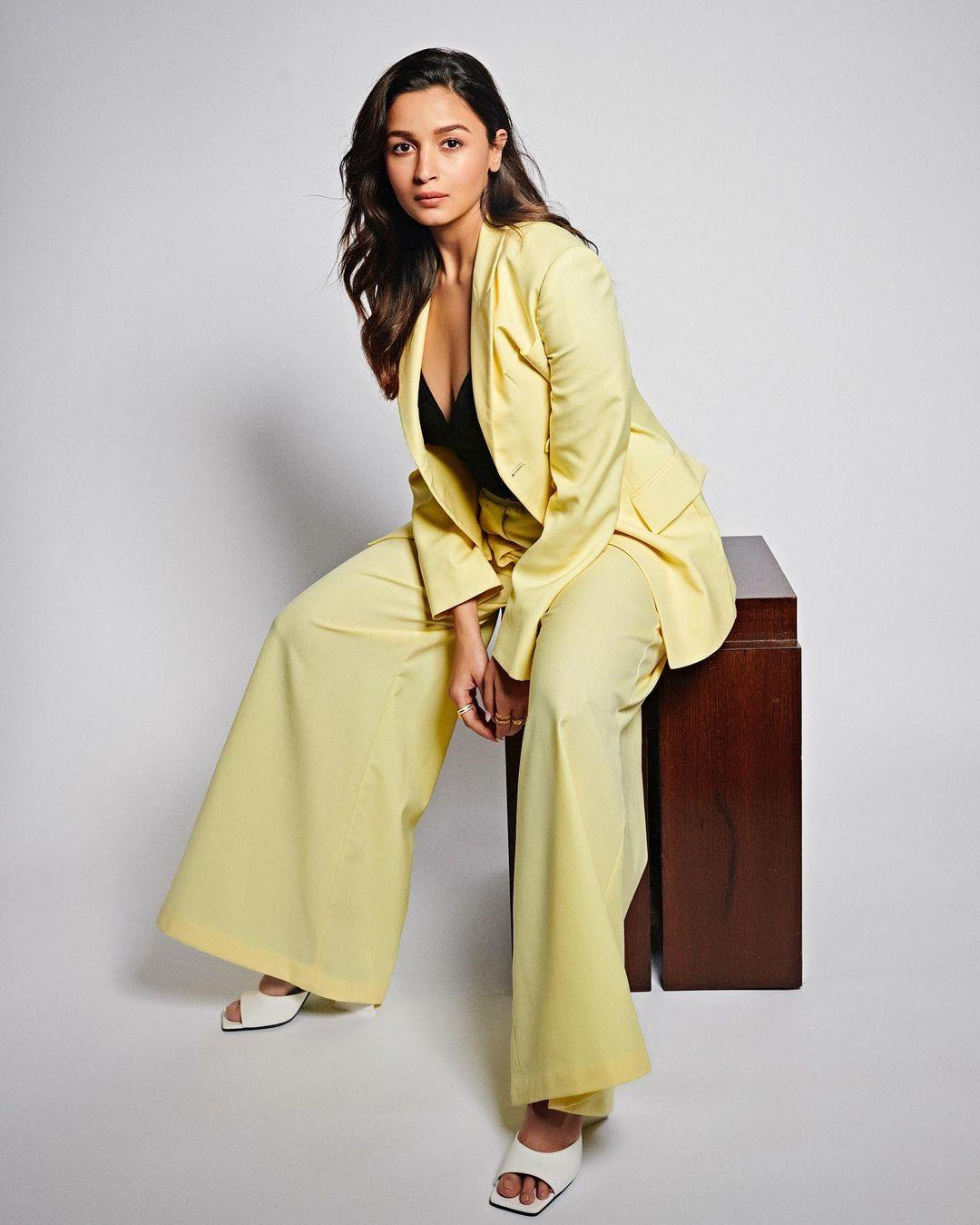 Underneath the jacket, she rocked a black top. Matching the jacket, the lime yellow pants had a flared hem and a fitted top, pulling together a chic and professional look.