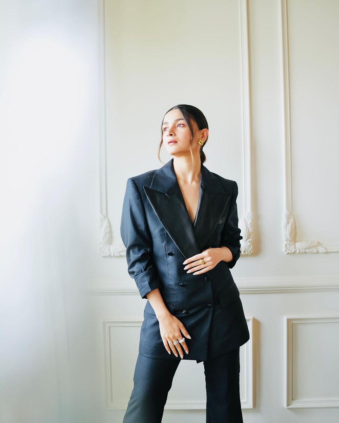 Alia Bhatt looked incredibly confident in a bold black oversized pantsuit, effortlessly channelling boss lady vibes. Her elegantly styled sleek braided ponytail perfectly complemented the powerful ensemble, completing the strong and poised corporate look.