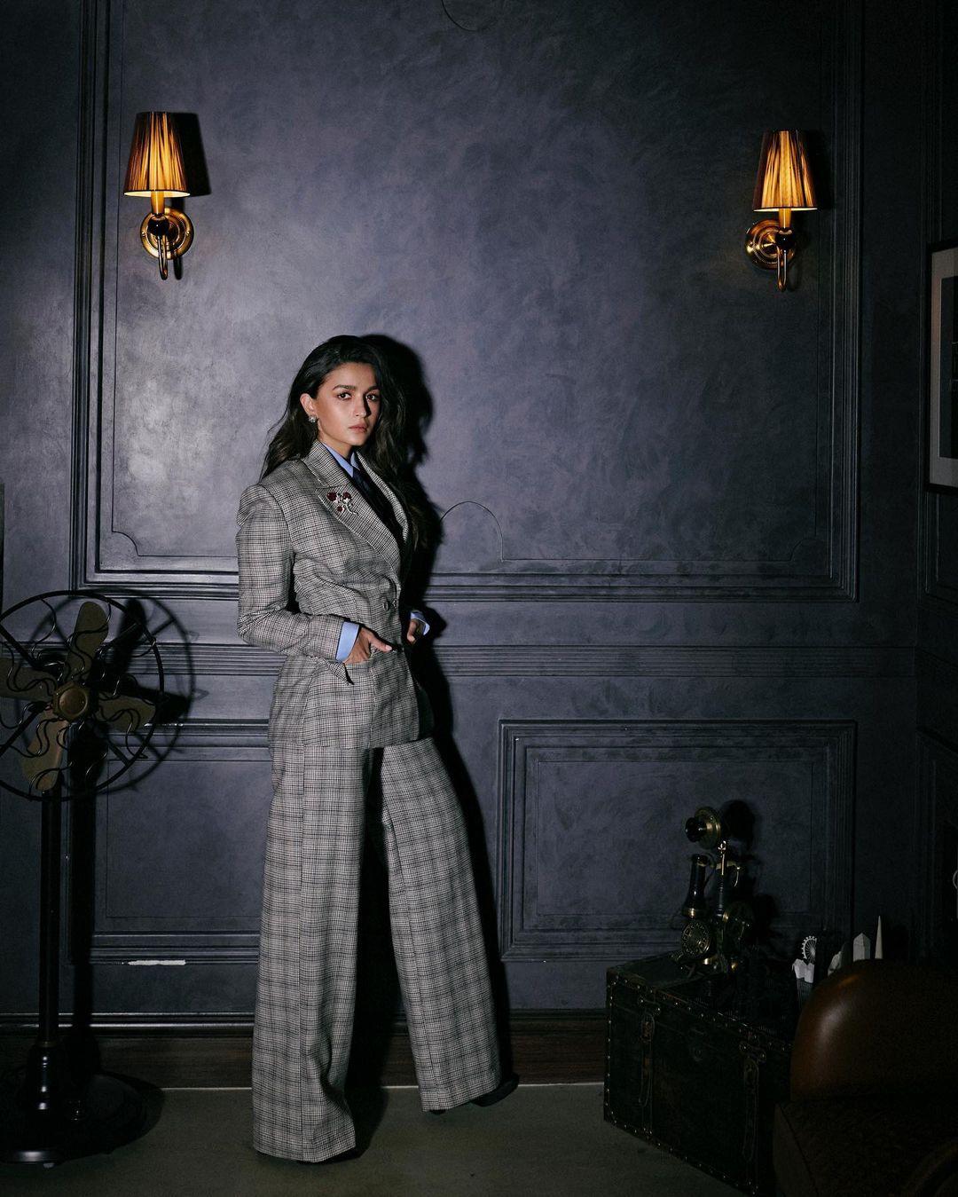 To make the outfit even better, Alia Bhatt picked a crisp powder blue button-up shirt, a classy navy blue tie, and a neatly folded pocket square. This combination radiates a professional and polished look, making it perfect for a corporate environment.