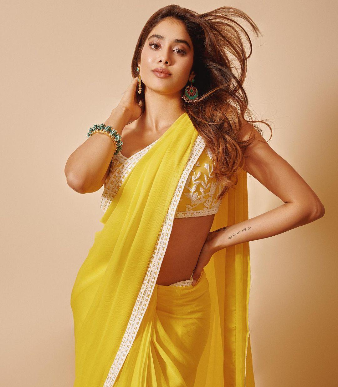  Janhvi Kapoor's traditional choices always leave us in awe. The actress effortlessly paired a plain yellow saree with a stunning embroidered blouse in this look