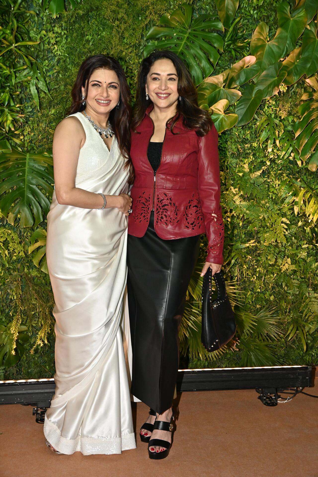 Bhagyashree poses with actress Madhuri Dixit. The latter looked uber-cool in a maroon jacket and black leather pants