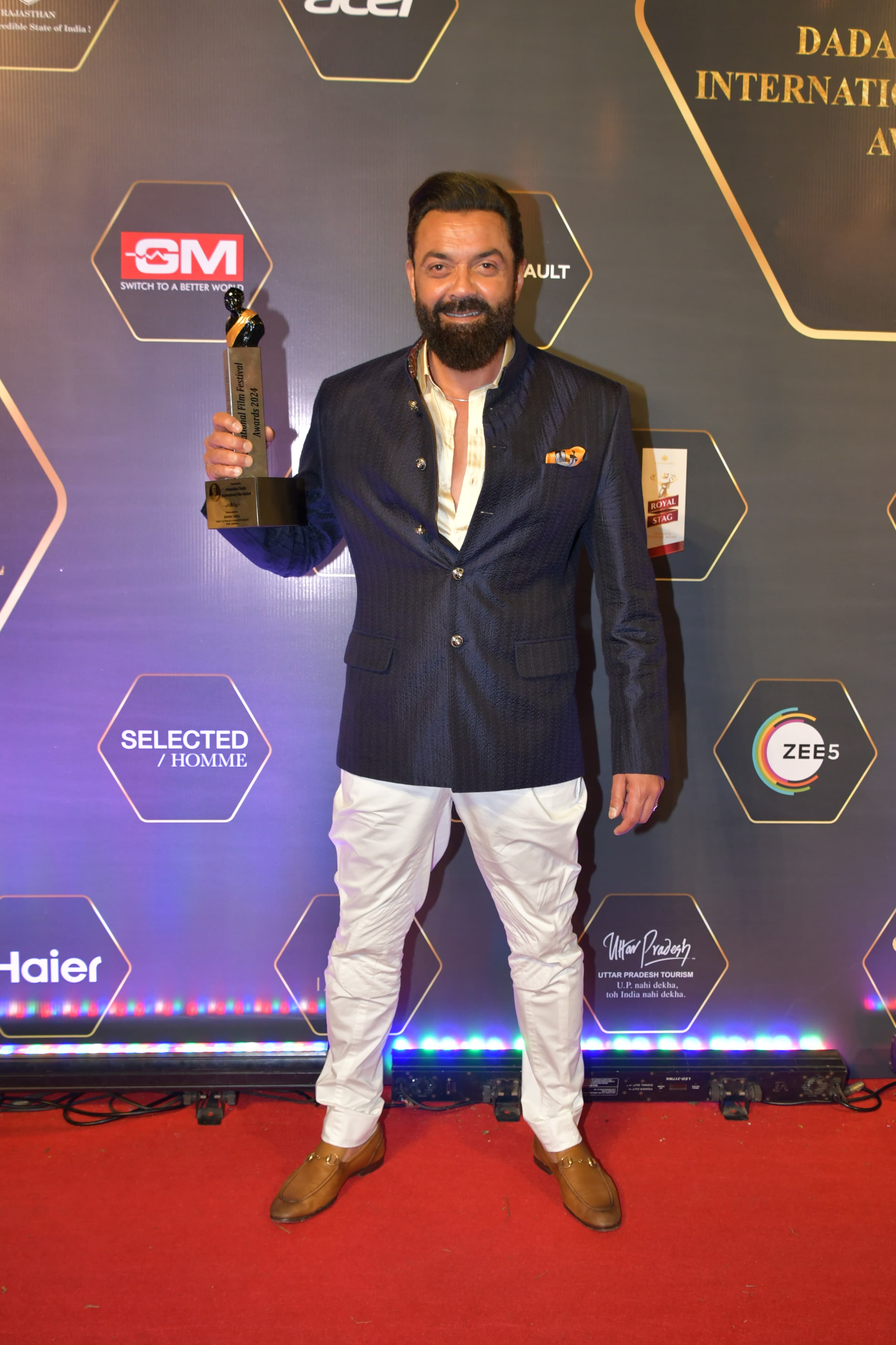 Animal actor Bobby Deol posed with his award on the red carpet