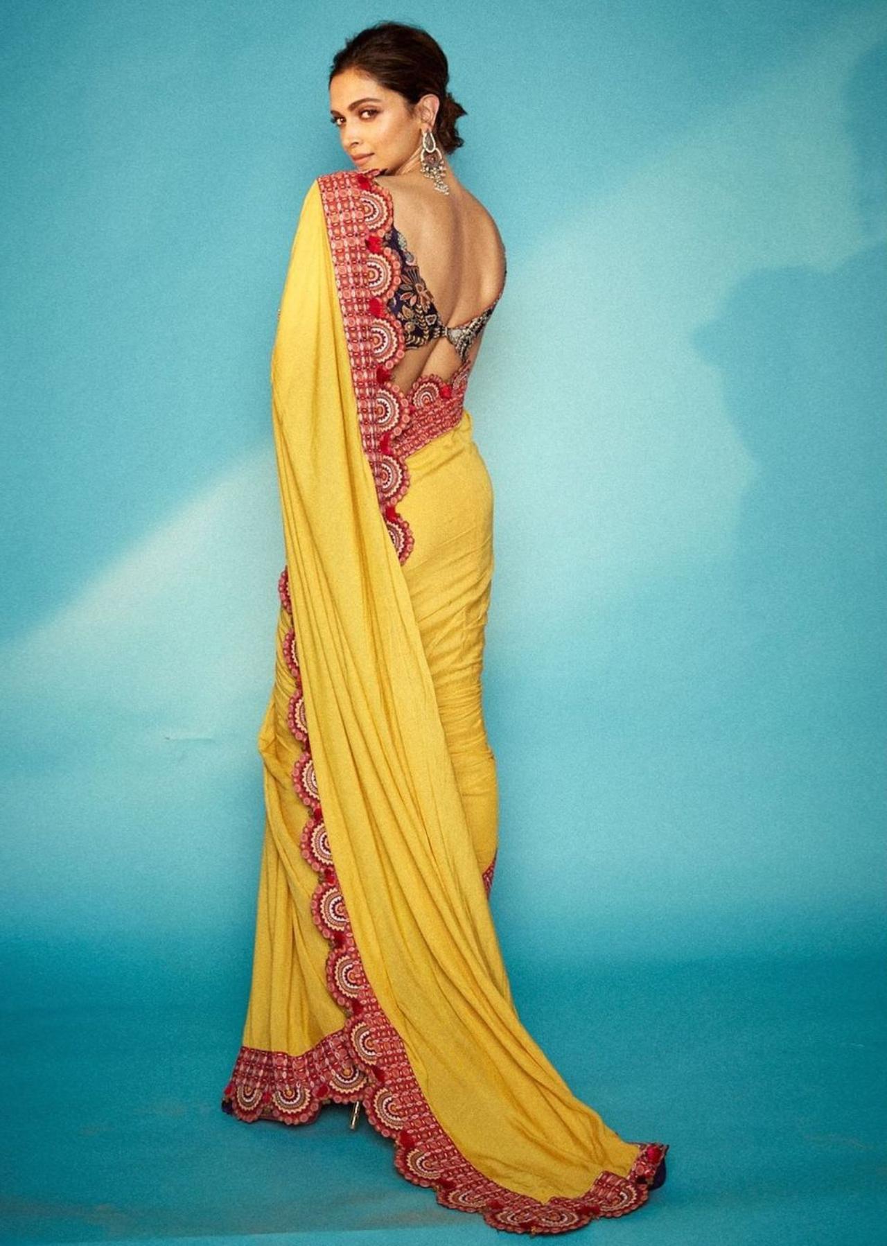 Deepika goes all out as she dons this yellow and red saree