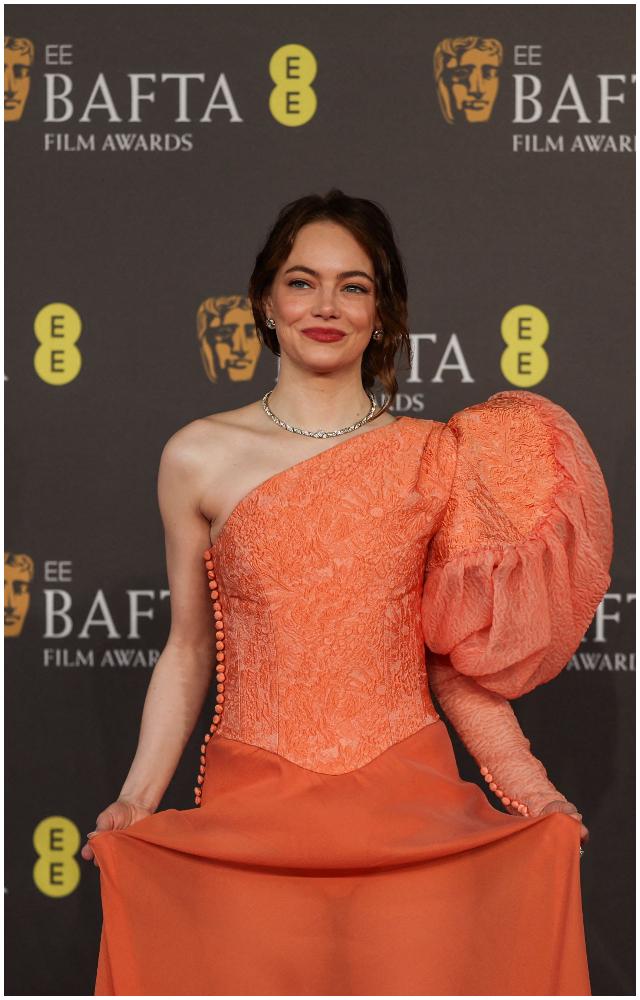 Emma Stone looked stunning in a peach one-shoulder gown with a statement puff sleeve in a nod to her Poor Things character, Bella Baxter