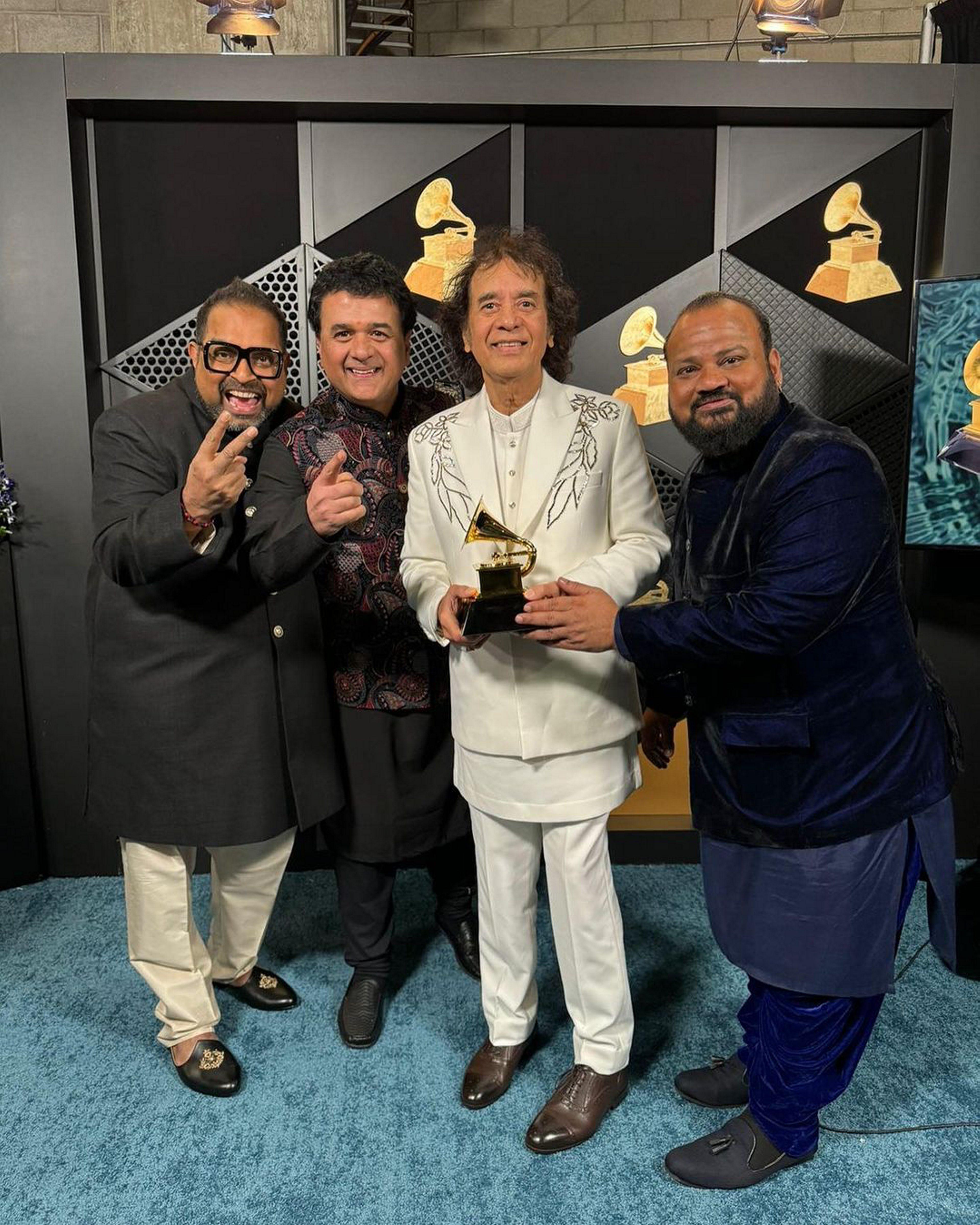 Ustad Zakir Hussain, vocalist Shankar Mahadevan, percussionist V Selvaganesh and violinist Ganesh Rajagopalan of Shakti pose for photos with the award for best global music album for 'This Moment' during the 66th annual Grammy Awards, in Los Angeles. (Photo: PTI)