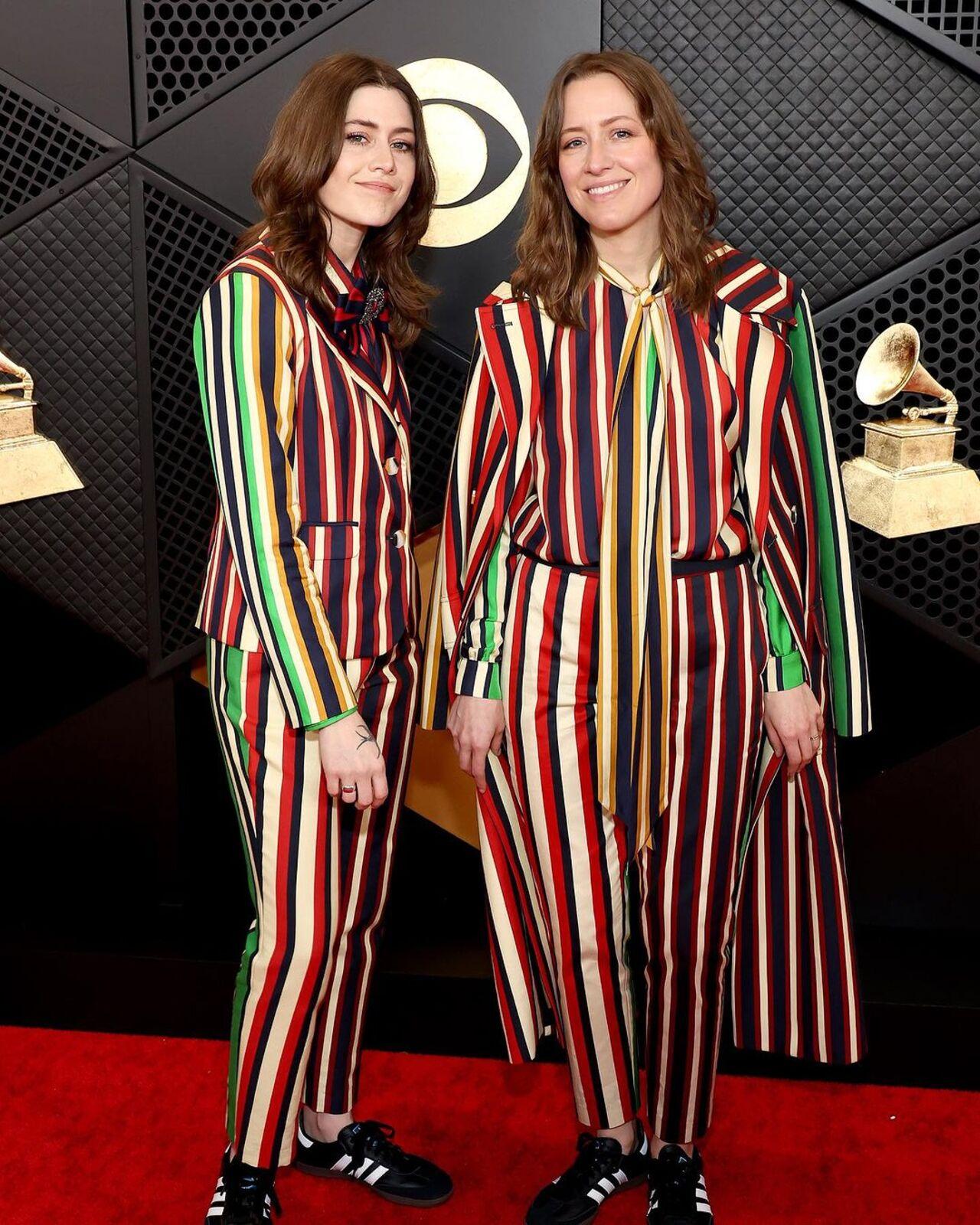Rebecca and Megan Lovell twin and win in this colourful striped suit for the big night