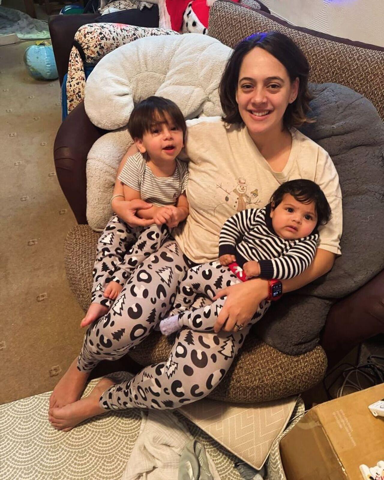 Happy mother Hazel twins and poses with her two kids