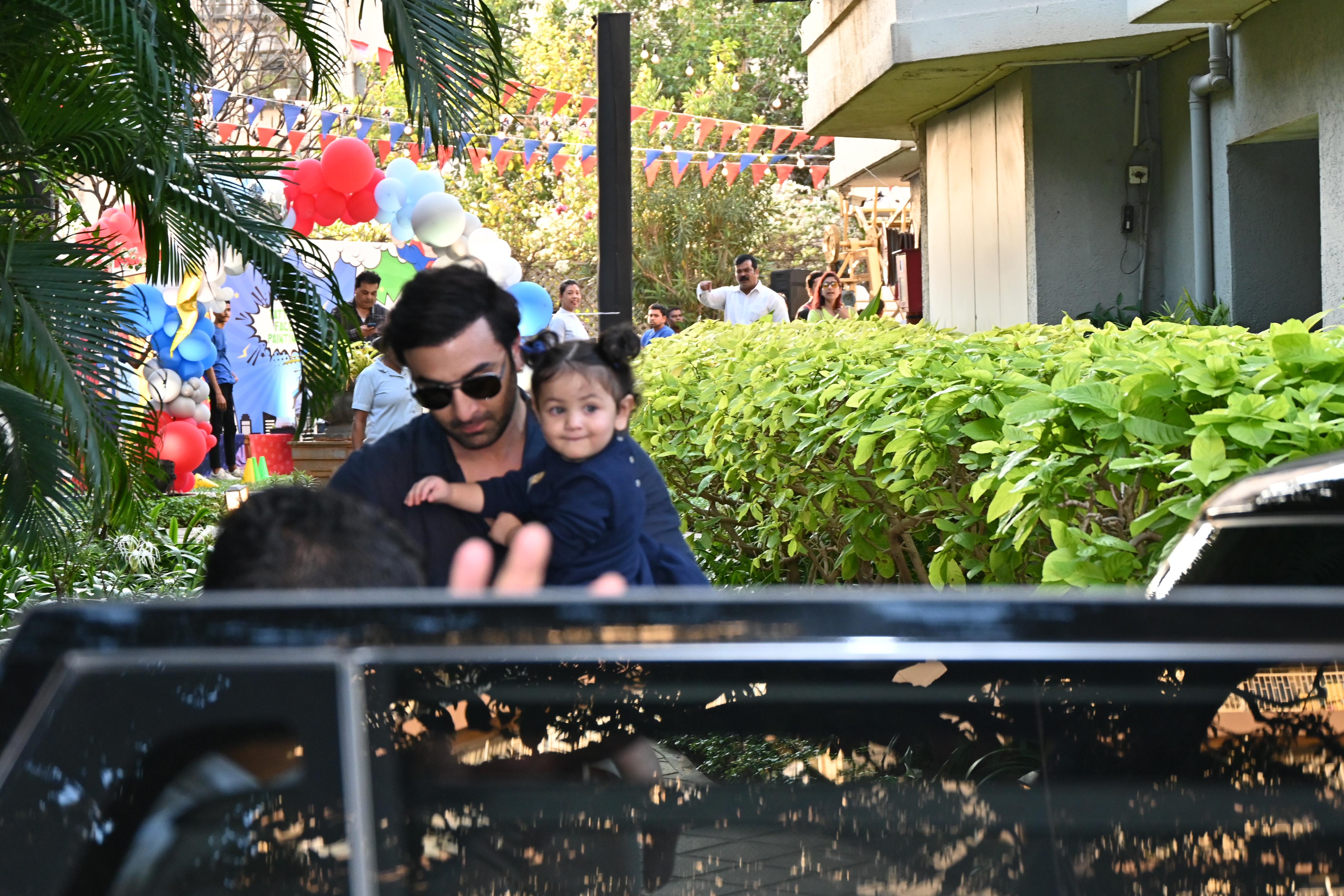 Dressed in blue, one-year-old Raha looked cute as a button as she was carried by papa Ranbir in his arms.