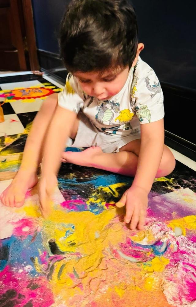 Jeh, just like any other toddler loves to play with colours, and here’s him giving some serious thought while making rangoli