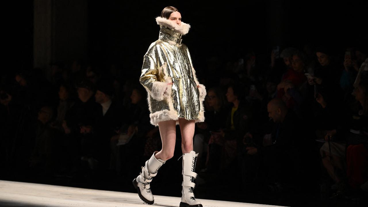 Antonio Marras presents his signature OTT style with an oversized bomber metallic jacket layered with fur, complemented by white strap boots. Pic/AFP
