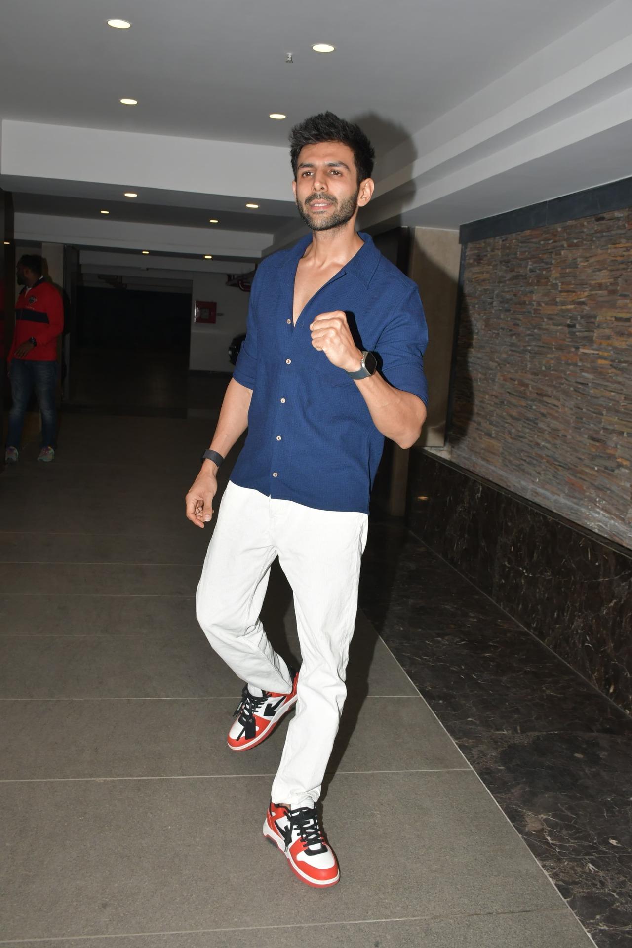Kartik Aaryan was seen in a bright blue shirt and white denims, all ready to party