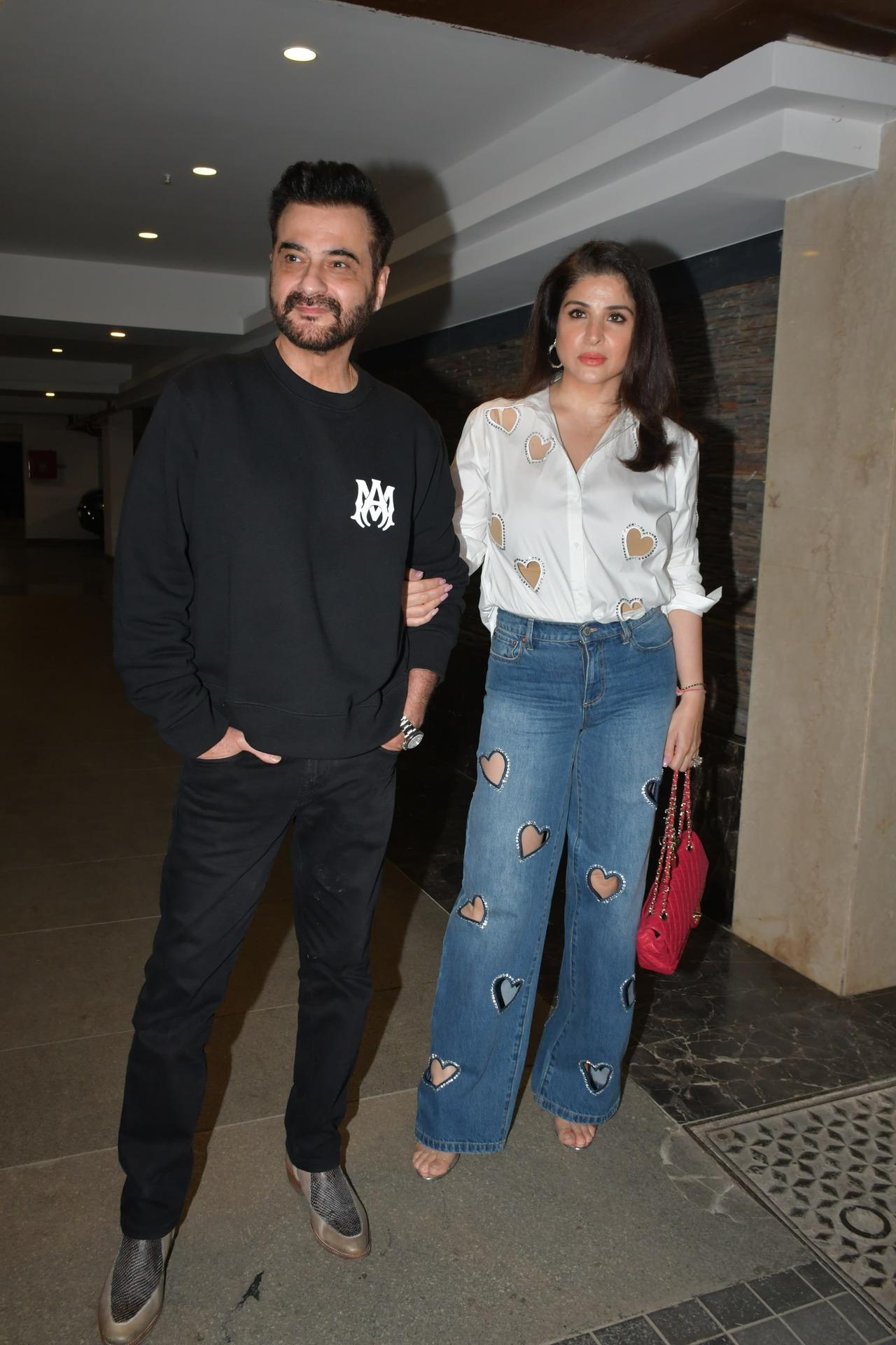 Sanjay Kapoor and Maheep Kapoor pose hand-in-hand as they arrive for the party