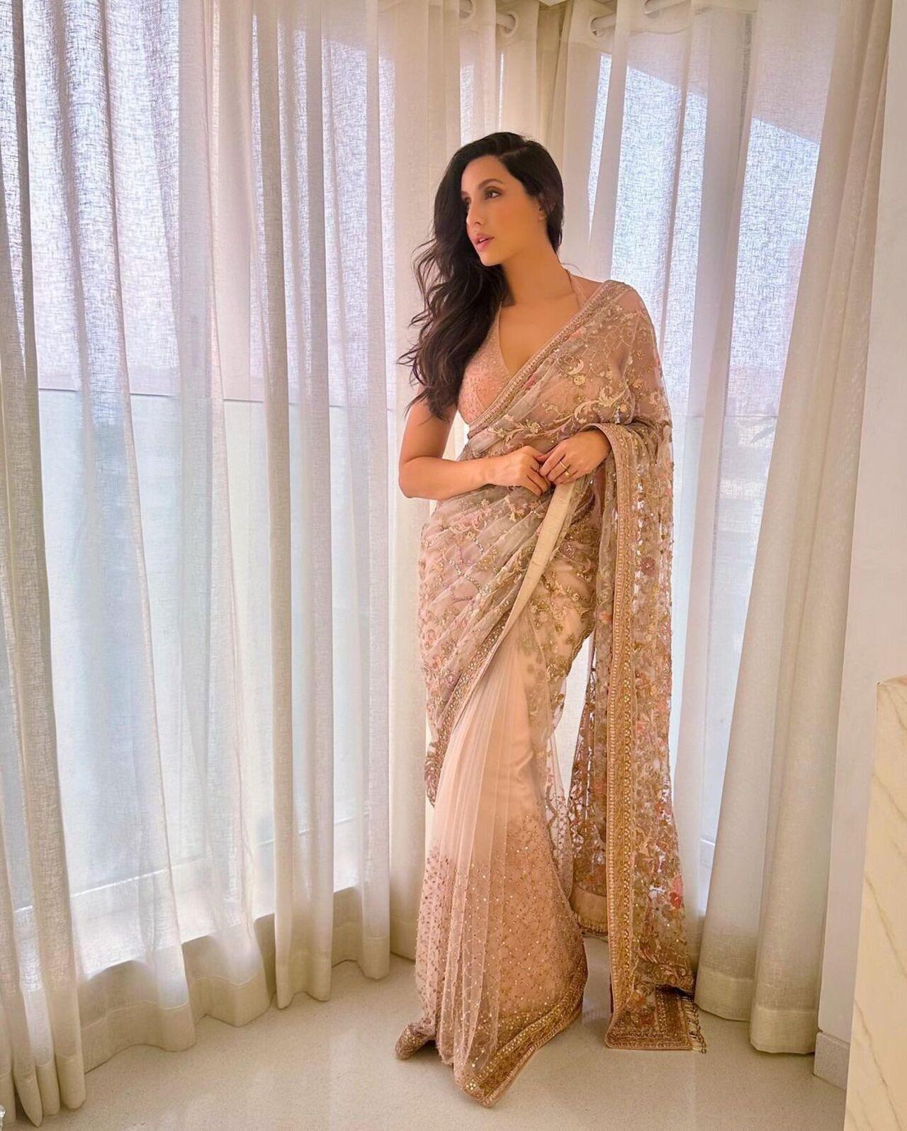 In the mood to show an elegant and rich look, a heavily embroidered pastel saree is the perfect fit
