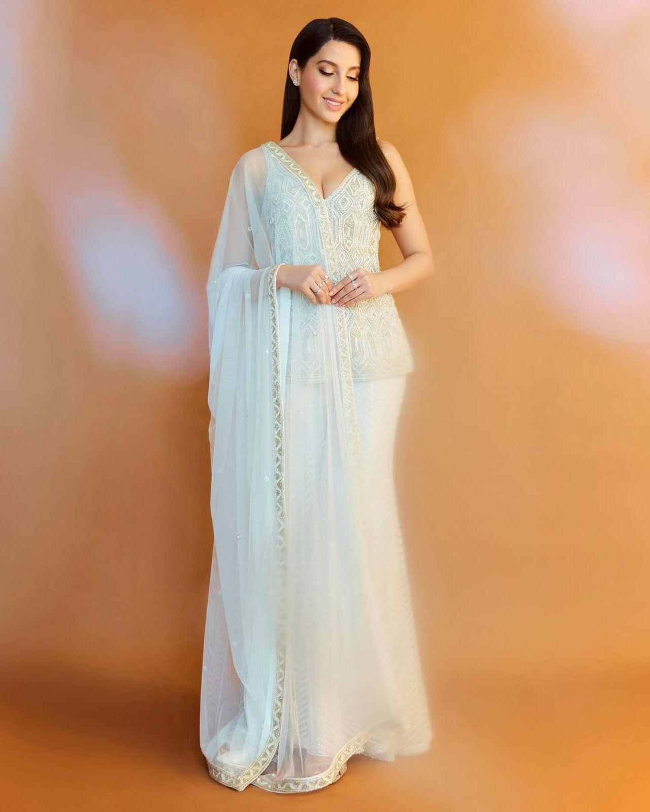 An all-white ensemble never looked better! While Indian traditional wear is usually all about colours, Nora manages to bring out the beauty of white with this sharara