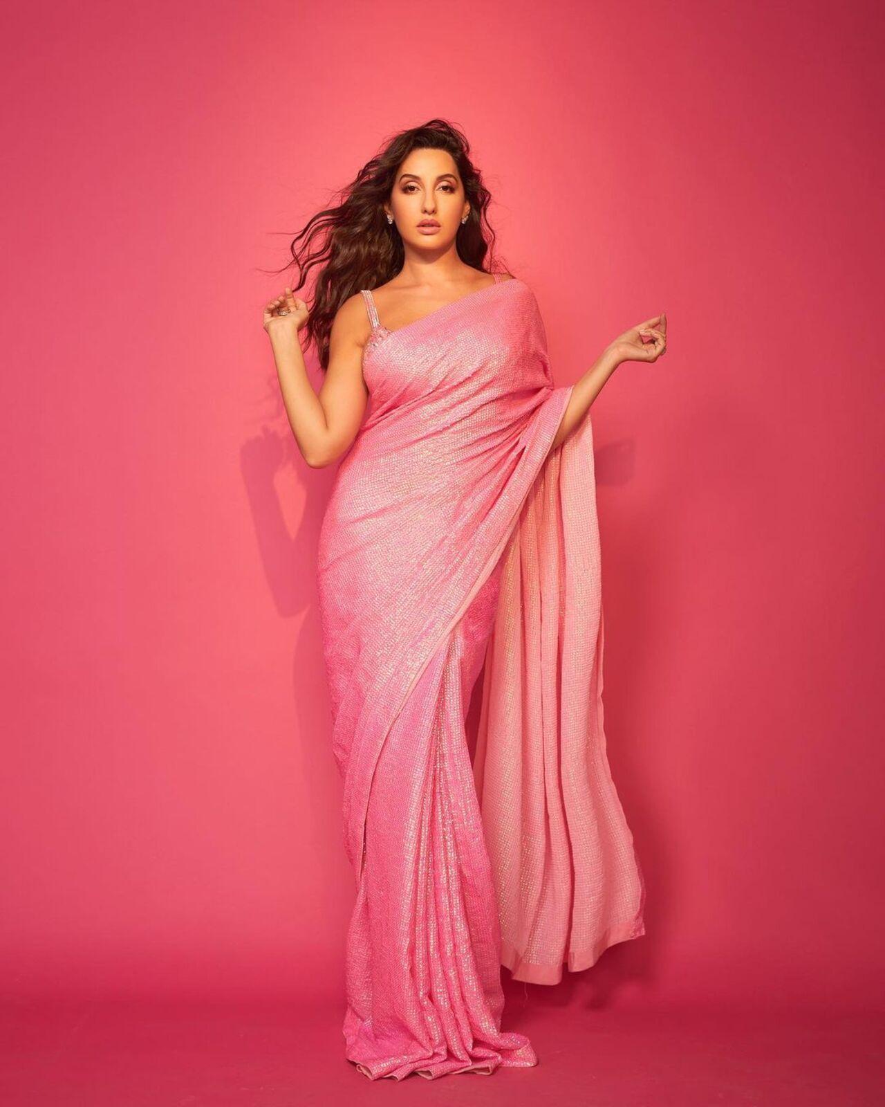 Nora shows how to glam up and be party-ready in a pink shimmery saree
