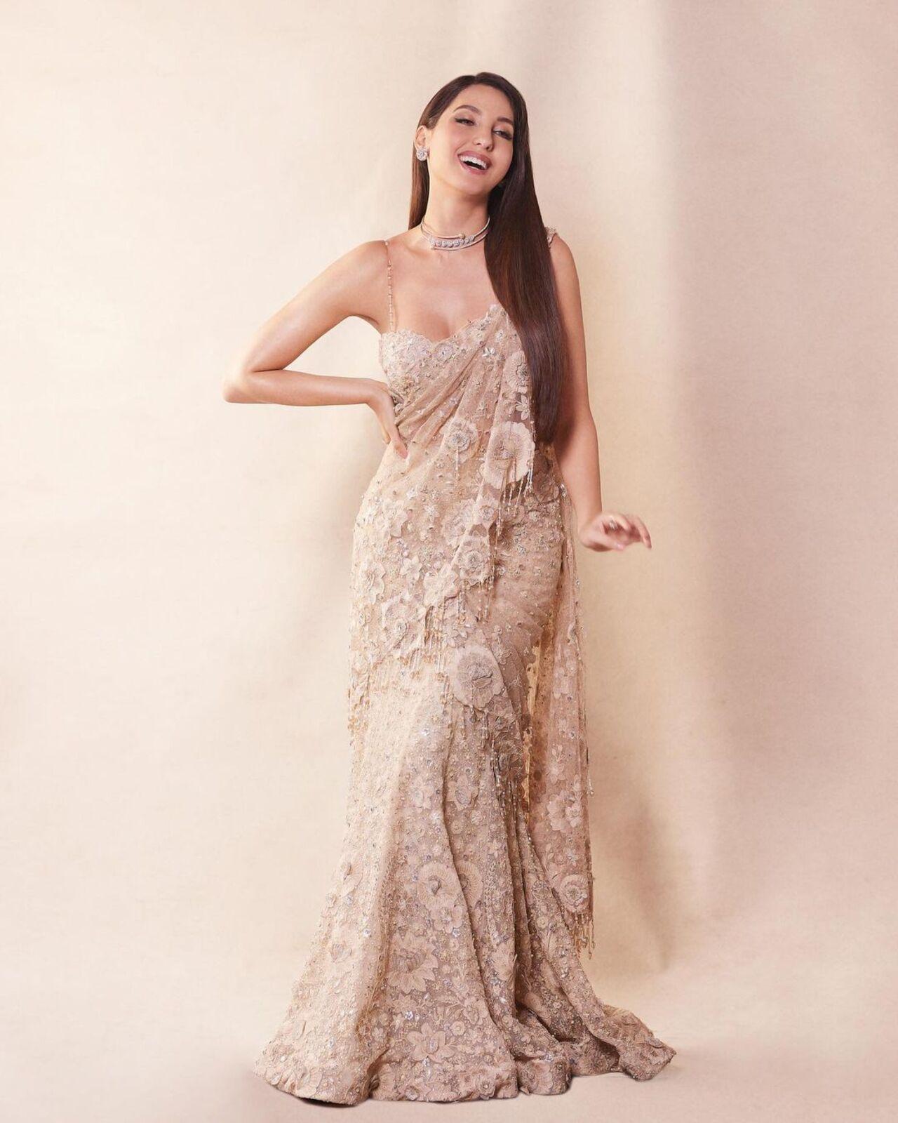 This Tarun Tahiliani creation comes with intricate work on the saree fabric with danglers on the pallu. Nora paired it with a noodle-strapped blouse and a diamond choker
