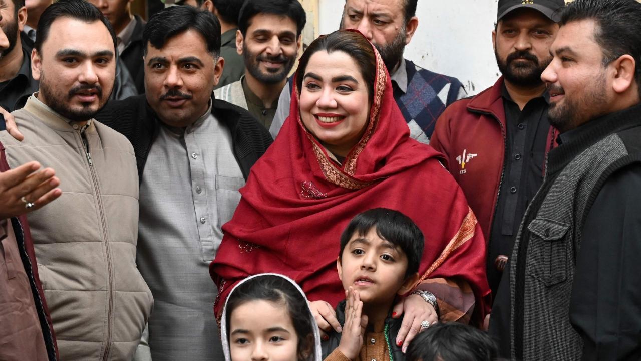 Samar Haroon Bilour, a candidate of the Awami National Party (ANP) stands beside party workers during an election campaign rally in Peshawar. She has taken over her husband's campaign when he was shot dead by militants shortly before the last election