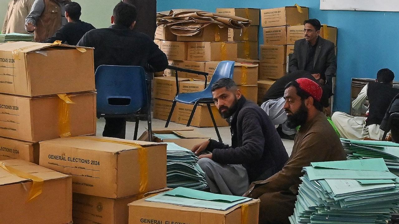 Workers preparing voting materials at a distributing centre in Islamabad on February 6