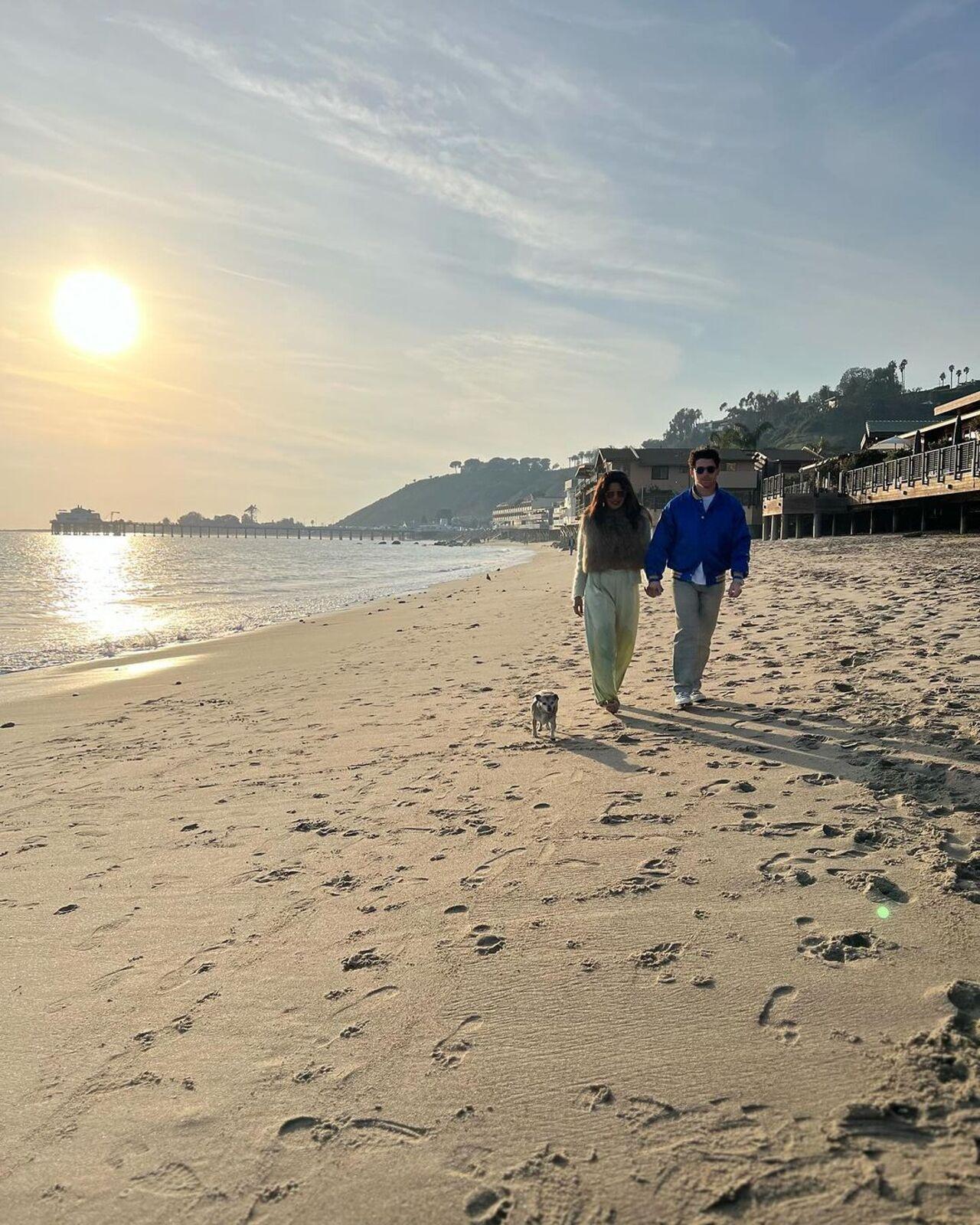 Nick and Priyanka take a stroll on the beach while holding hands