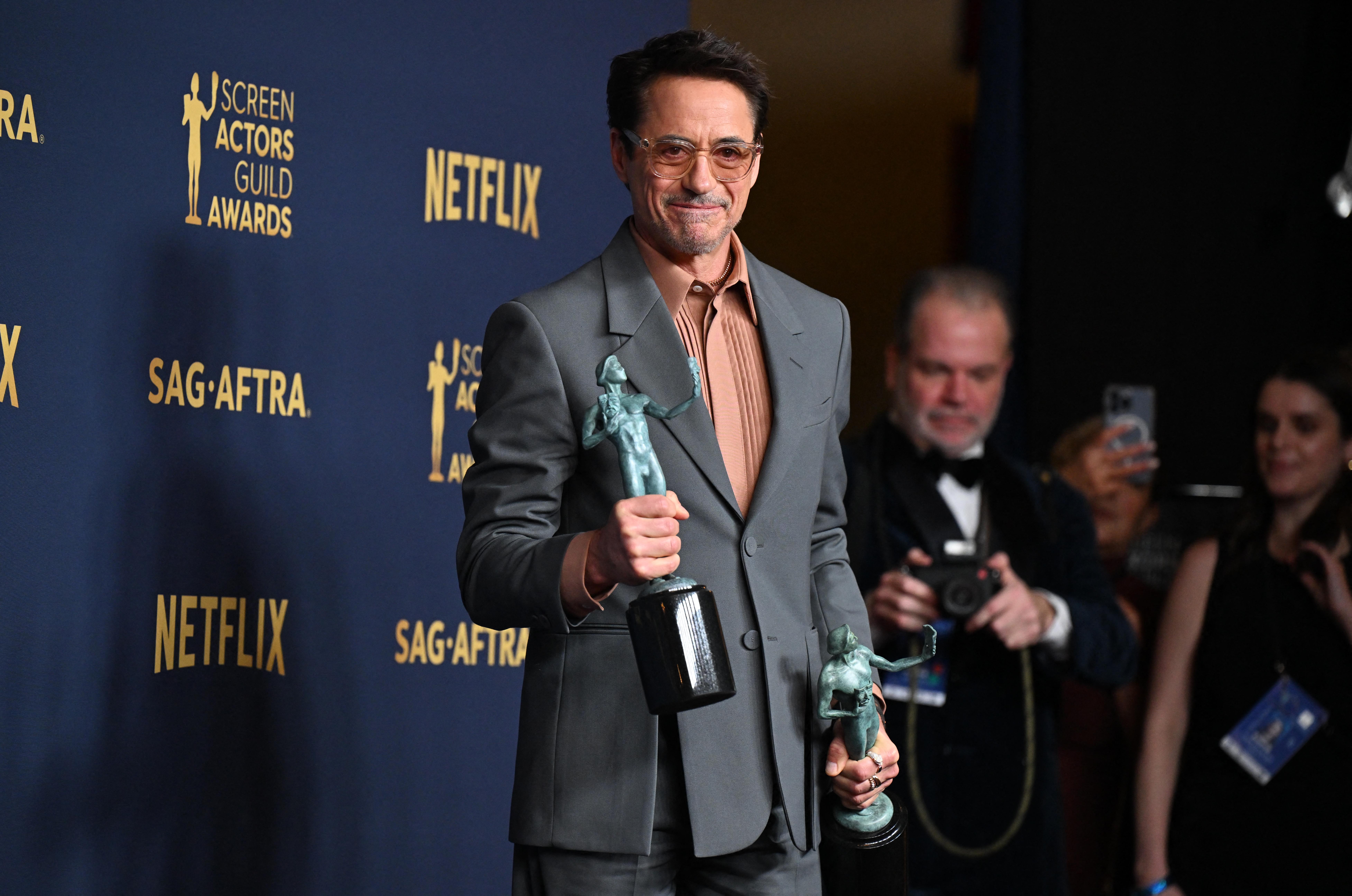 Robert Downey Jr., winner of the Outstanding Performance by a Male Actor in a Supporting Role award and the Outstanding Performance by a Cast in a Motion Picture award for 'Oppenheimer' posed in the press room during the 30th Annual Screen Actors Guild Awards 