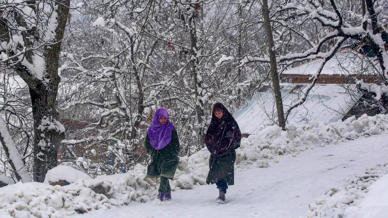 Girls walking on a snow-covered road after a fresh snowfall on Saturday