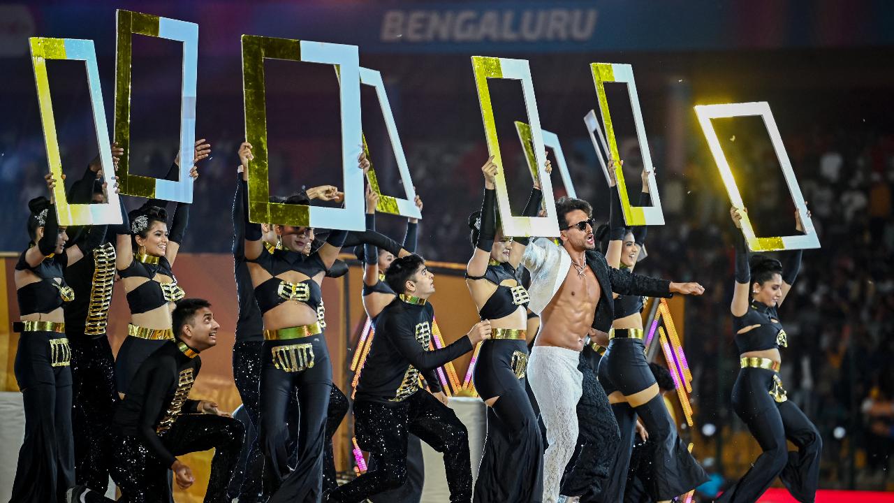 Actor Tiger Shroff (3R) performs during the opening ceremony of 2024 Women's Premier League (WPL) before the start of first Twenty20 cricket match between Mumbai Indians and Delhi Capitals at the M. Chinnaswamy Stadium in Bengaluru