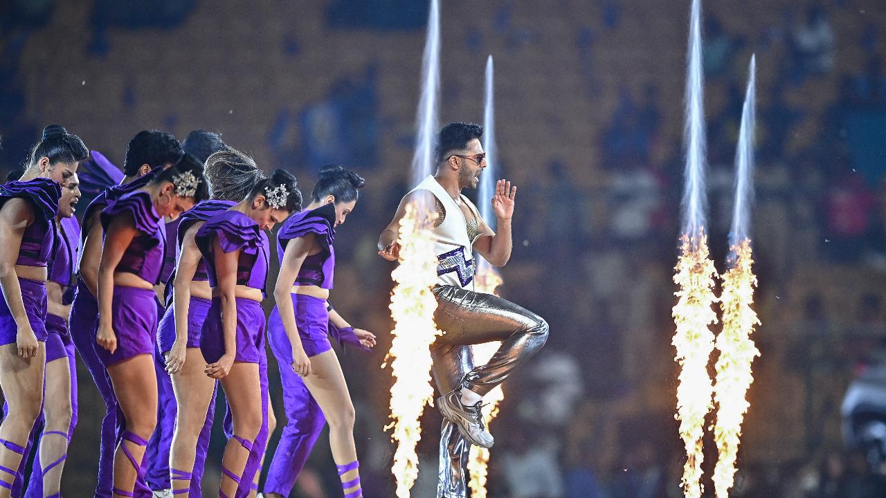 Bollywood actor Varun Dhawan (R) performs for the opening ceremony of 2024 Women's Premier League (WPL) before the start of first Twenty20 cricket match
