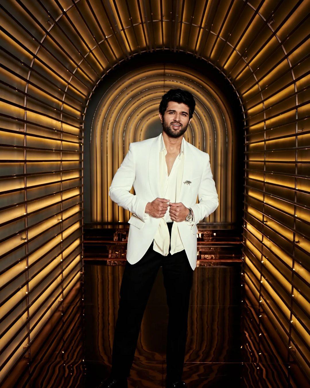 Vijay Deverakonda was seen wearing the white tuxedo suit as he made a stylish visit to the Koffee with Karan show, looking like a complete 'Cheese Platter'