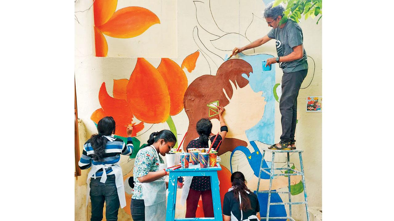 Volunteers paint the walls at a school