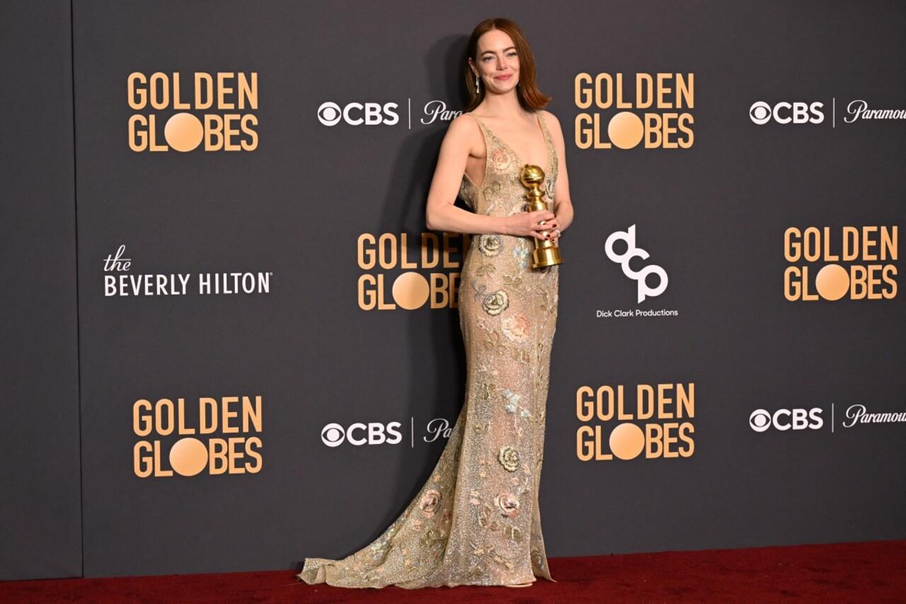 Emma Stone was a vision in this silhouette gown as she poses with her Best Actress award in a motion picture-musical/comedy for the film 'Poor Things'
