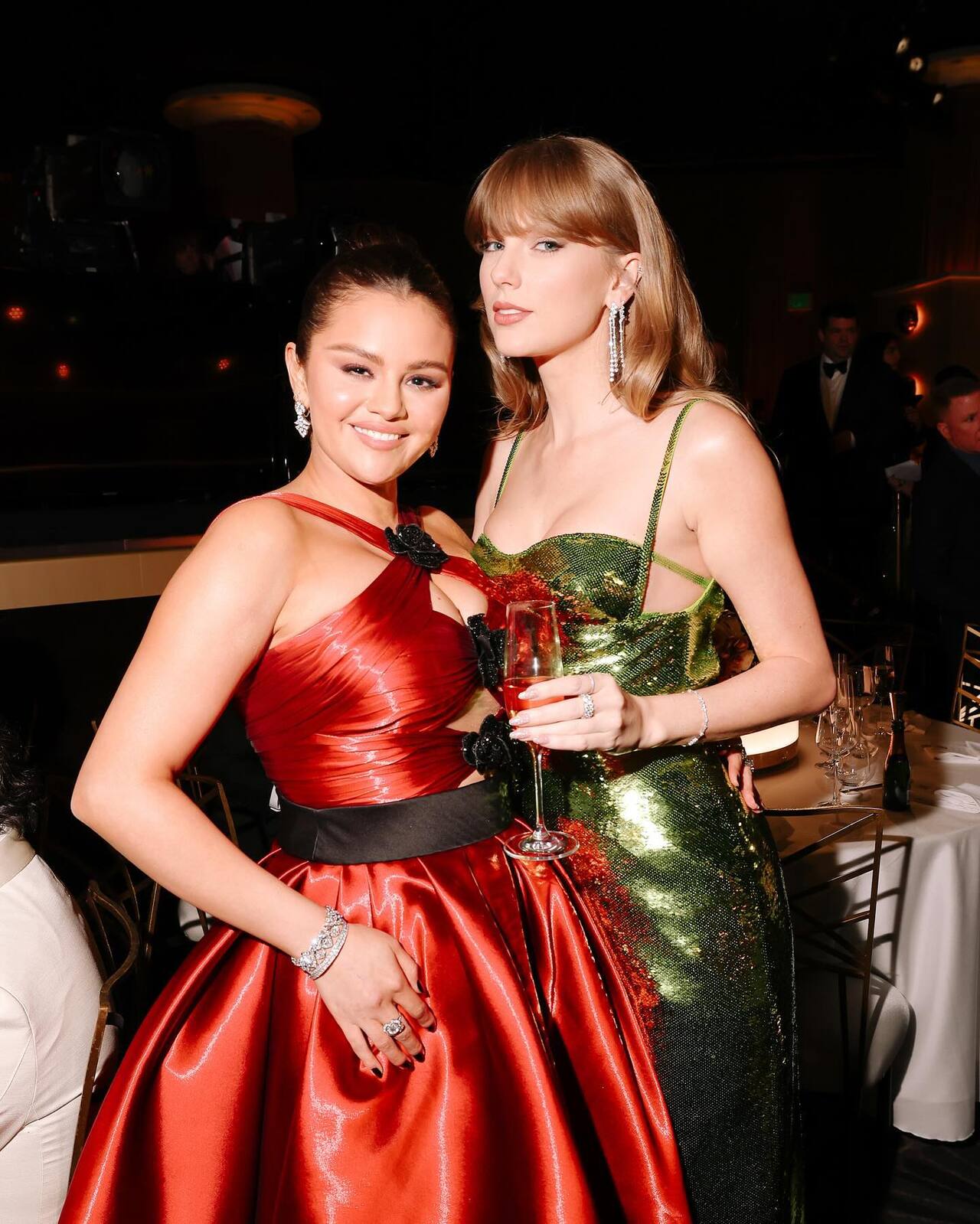 Taylor Swift made heads turn in a sparkly green outfit and posed with close friend Selena Gomez who was dressed in red outfit